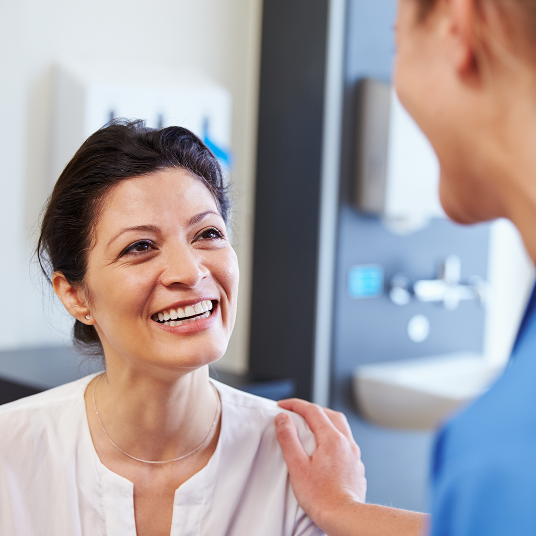Happy woman talking to her doctor