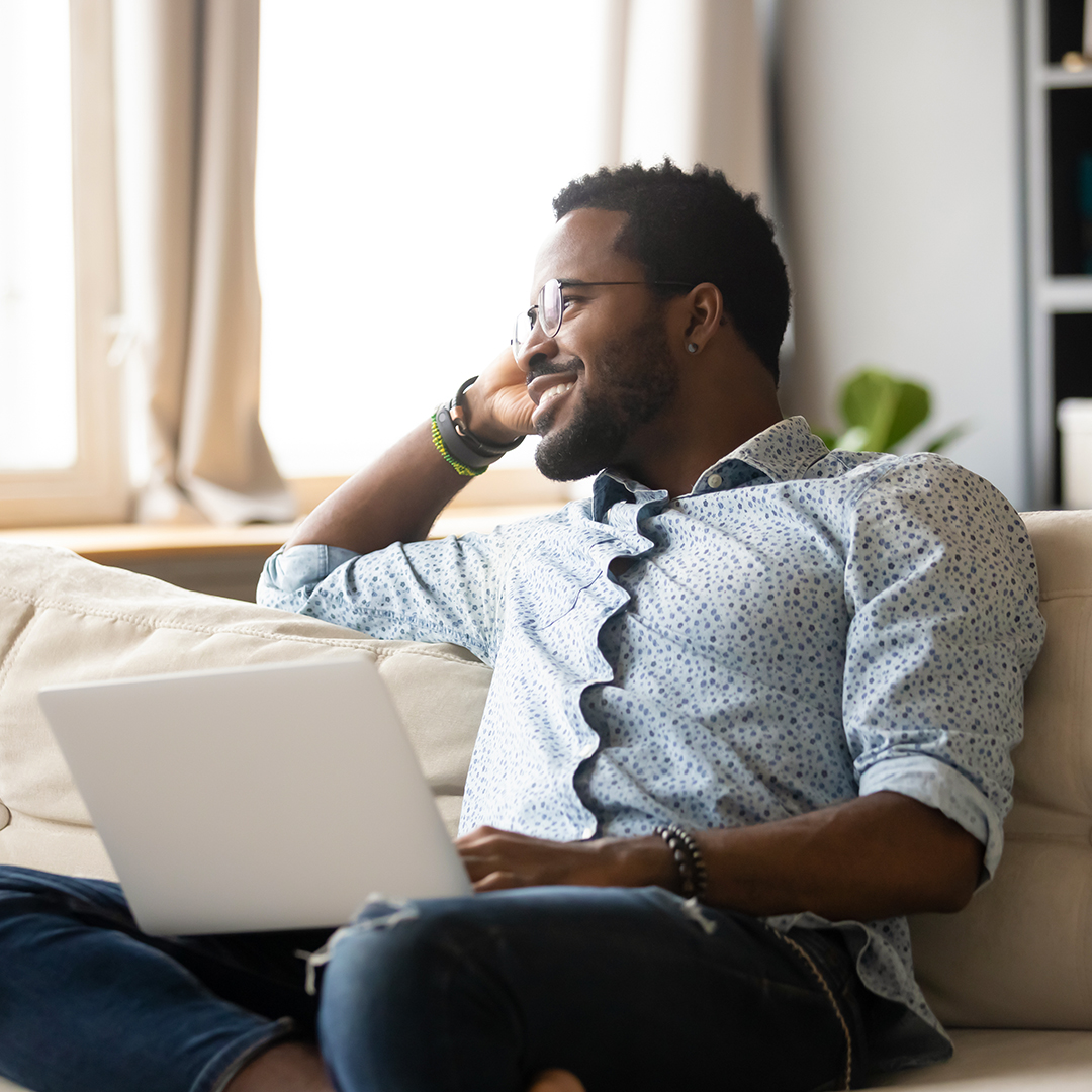 Happy man using a laptop