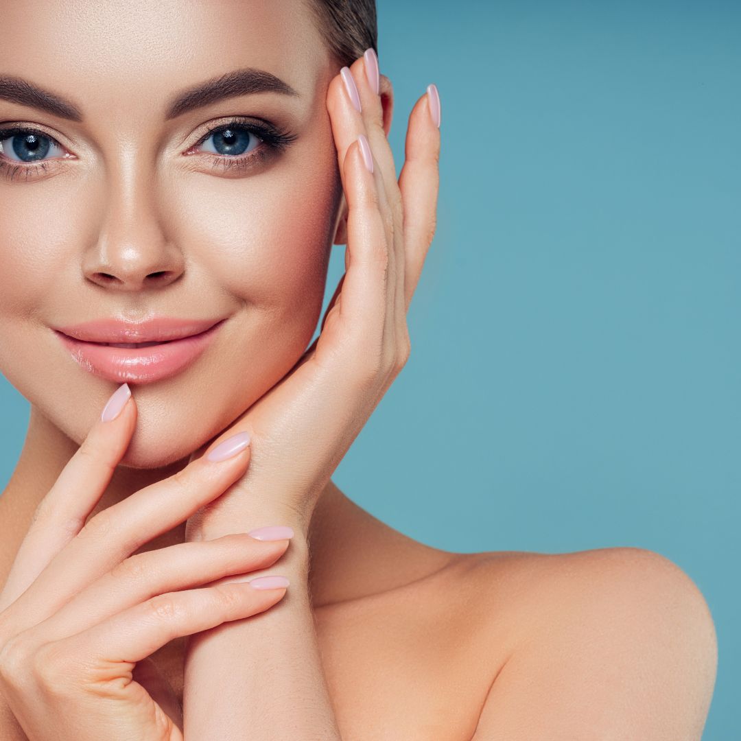 Close up of a woman smiling with her hands on her face