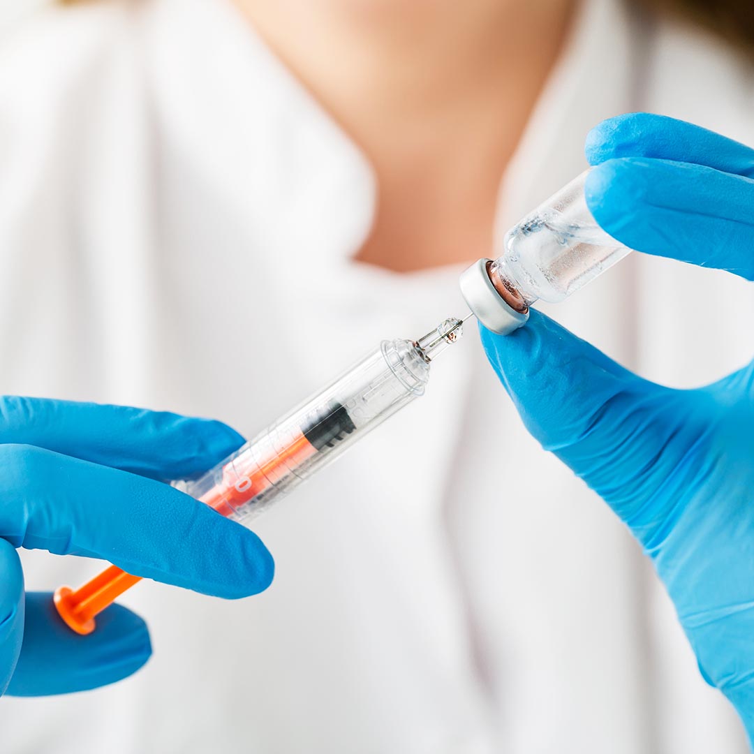 dermatologist filling a syringe with botox