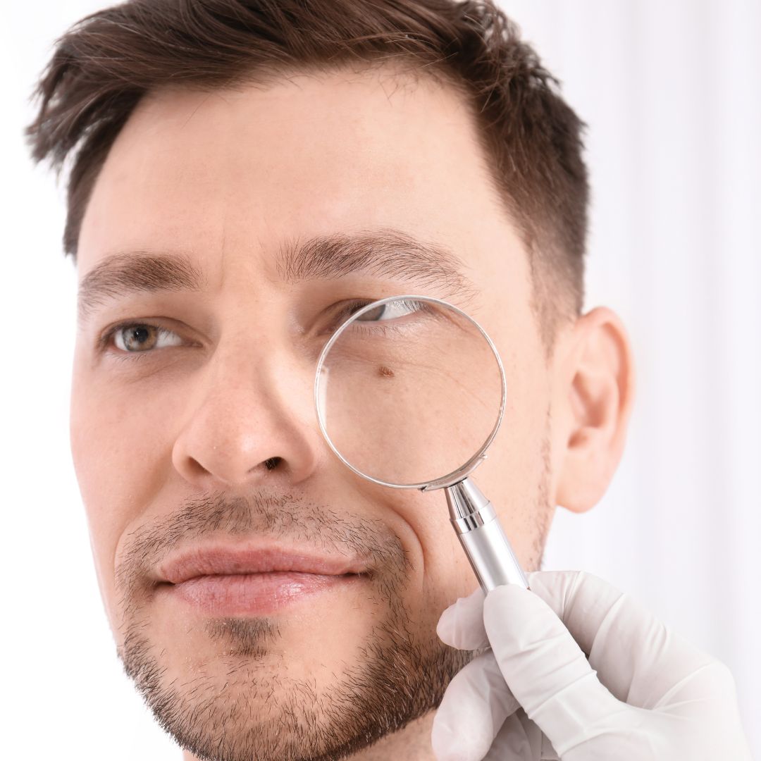 Examining male dermatology patient