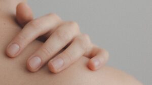 Hand placed on bare shoulder