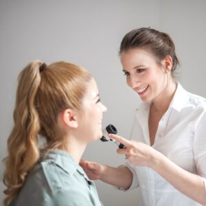 a woman talking with a dermatologist