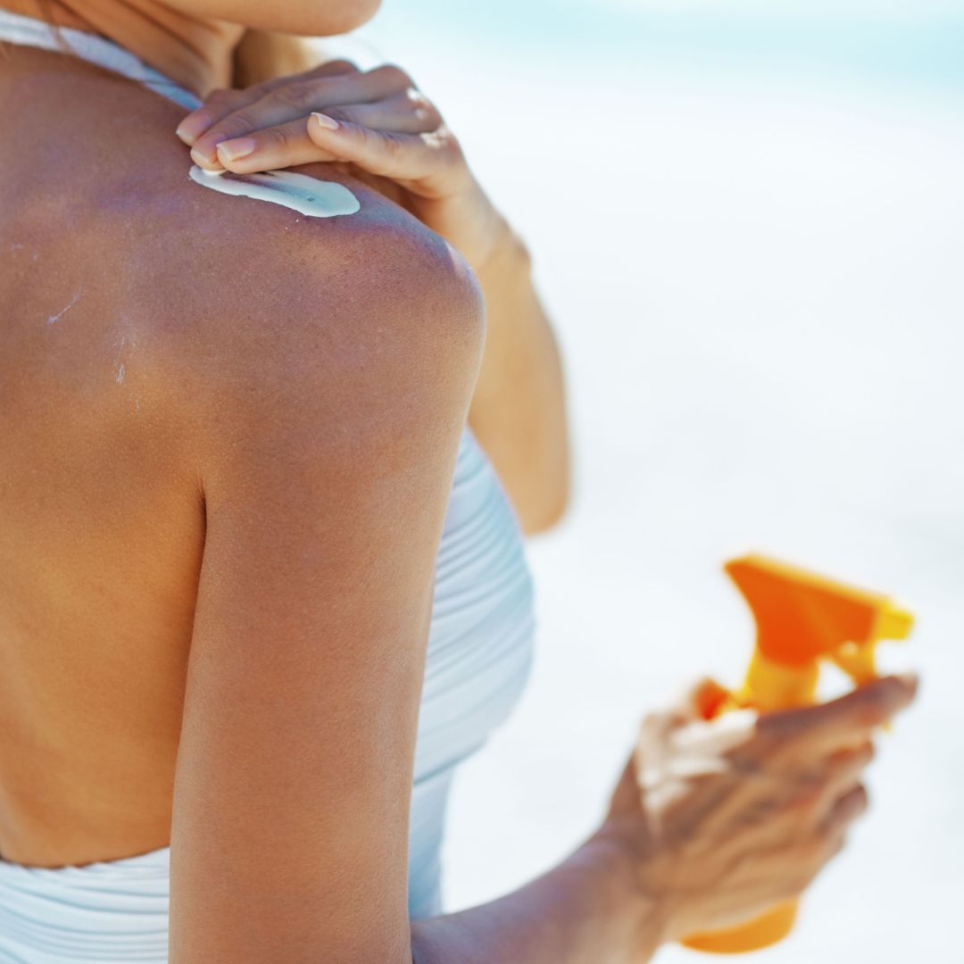 a woman applying sunscreen