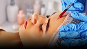 Woman receiving cosmetic injection for forehead lines