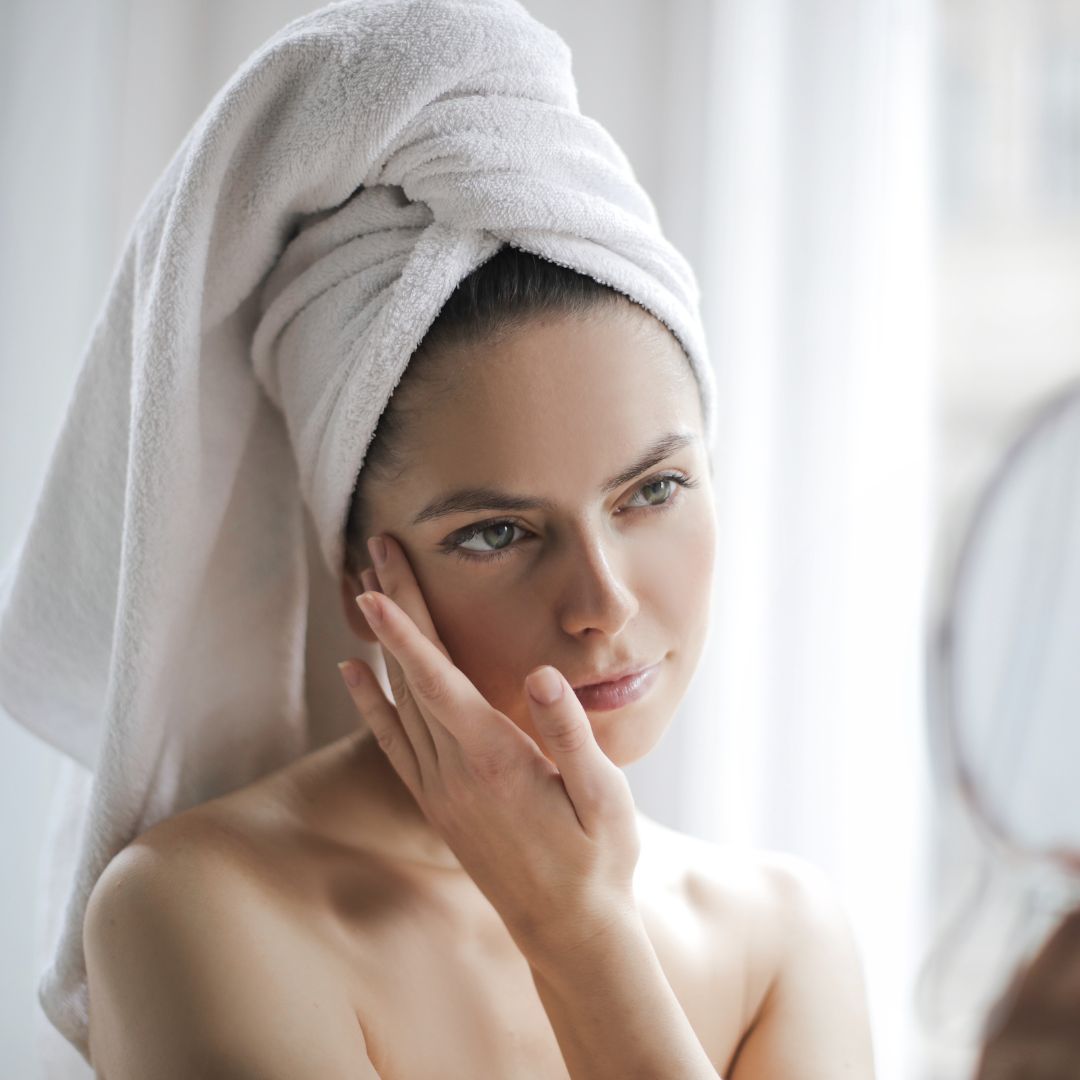 Women examining her skin in the mirror