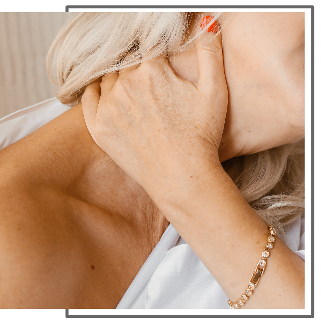 woman holding her neck